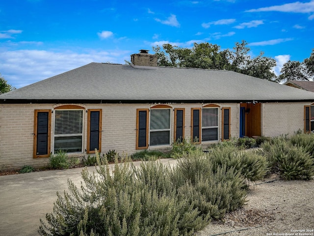 414 E Hathaway Dr, San Antonio, TX 78209 - view of front of property featuring brick siding, a chimney, and roof with shingles