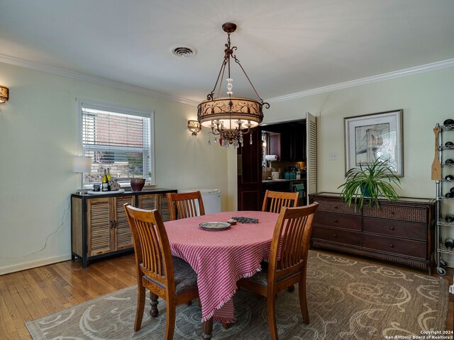 414 E Hathaway Dr, San Antonio, TX 78209 - dining space featuring visible vents, wood finished floors, baseboards, a chandelier, and ornamental molding