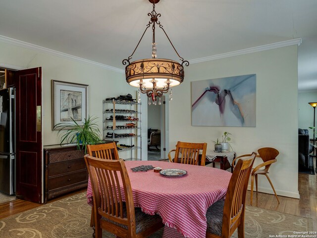 414 E Hathaway Dr, San Antonio, TX 78209 - dining room featuring baseboards, ornamental molding, and wood finished floors