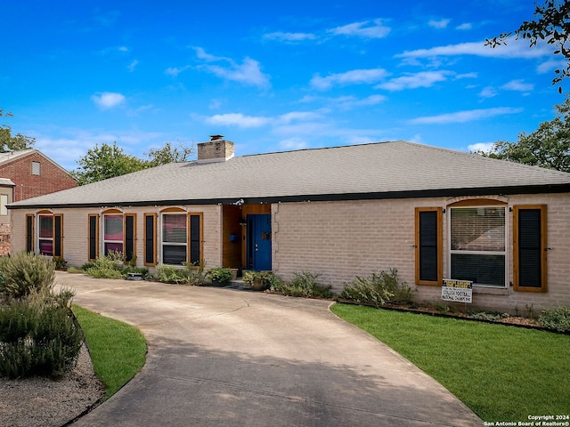 ranch-style home with a front lawn