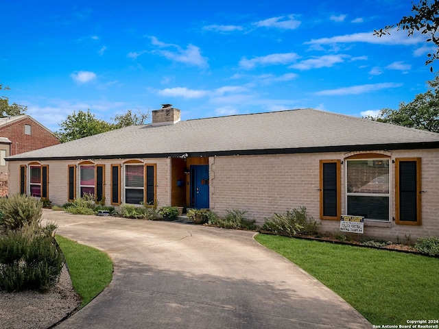 414 E Hathaway Dr, San Antonio, TX 78209 - ranch-style house with brick siding, roof with shingles, a front yard, and a chimney