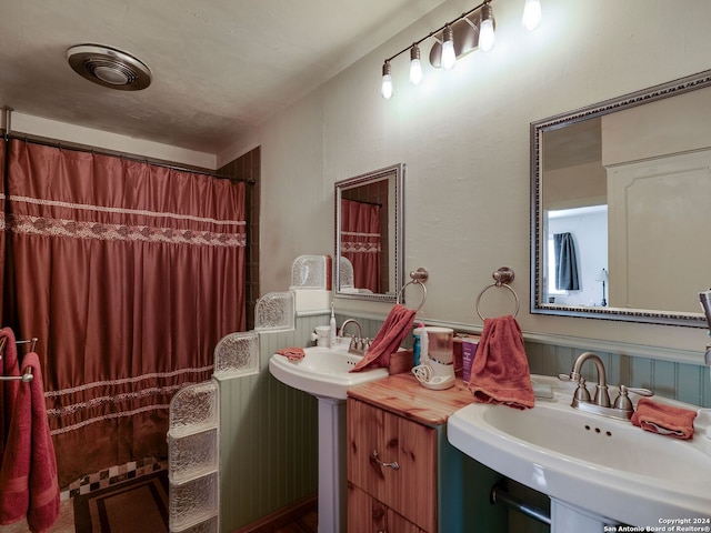 414 E Hathaway Dr, San Antonio, TX 78209 - bathroom with wainscoting, curtained shower, and a sink