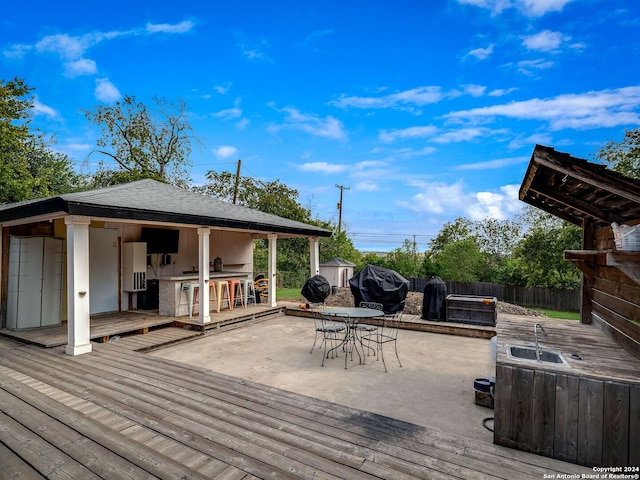 414 E Hathaway Dr, San Antonio, TX 78209 - wooden terrace featuring fence, exterior kitchen, an outdoor bar, outdoor dining area, and a sink