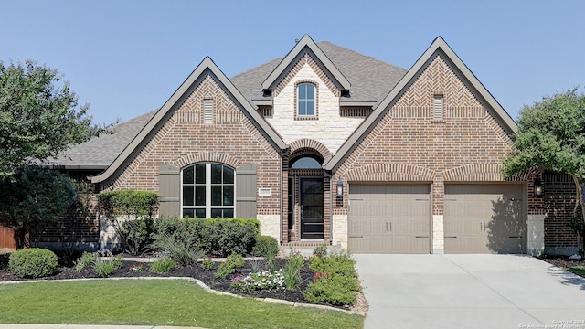 view of front of home featuring a front yard and a garage