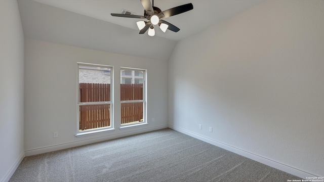 empty room with lofted ceiling, carpet floors, and ceiling fan