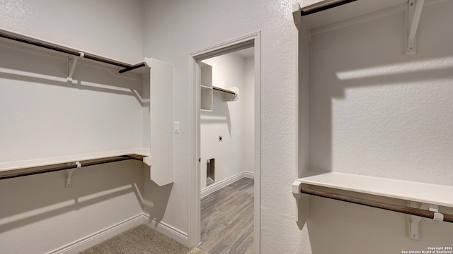 walk in closet featuring light hardwood / wood-style flooring