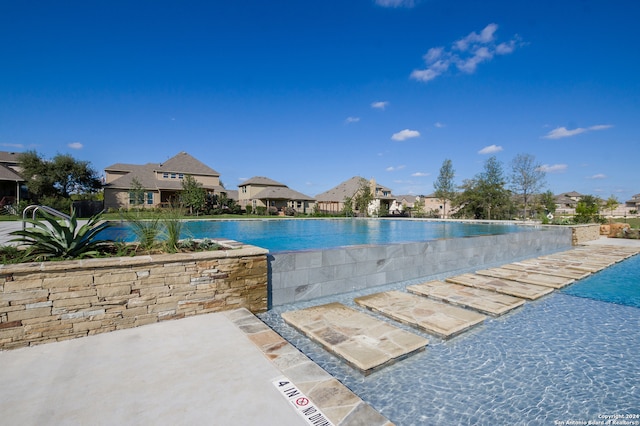 view of swimming pool with a patio