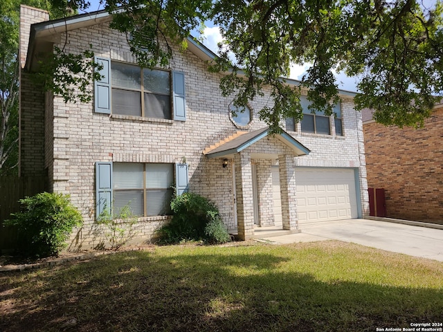 view of front of house with a front yard and a garage