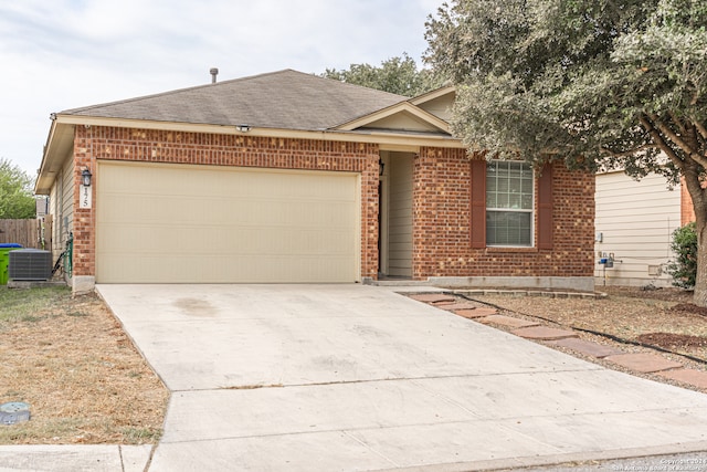 ranch-style house with central AC unit and a garage