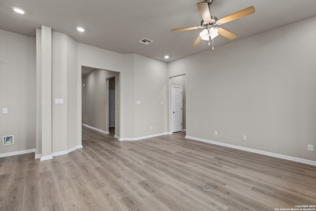 spare room with baseboards, ceiling fan, wood finished floors, and visible vents