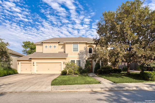 view of front of property featuring a front lawn and a garage