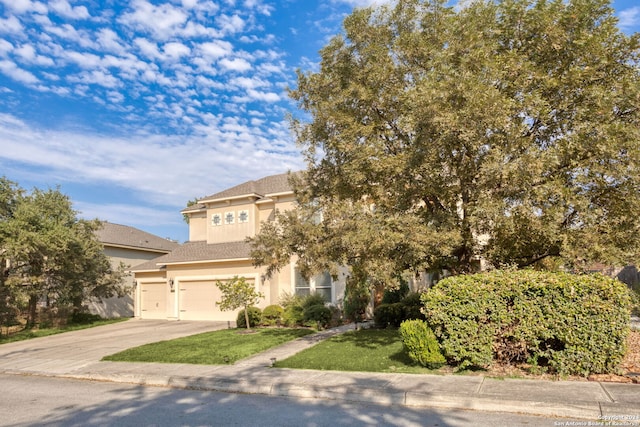 view of front of home with a front yard and a garage