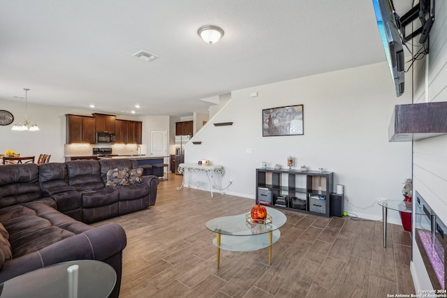 living room with hardwood / wood-style floors and sink