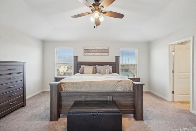 carpeted bedroom with multiple windows and ceiling fan