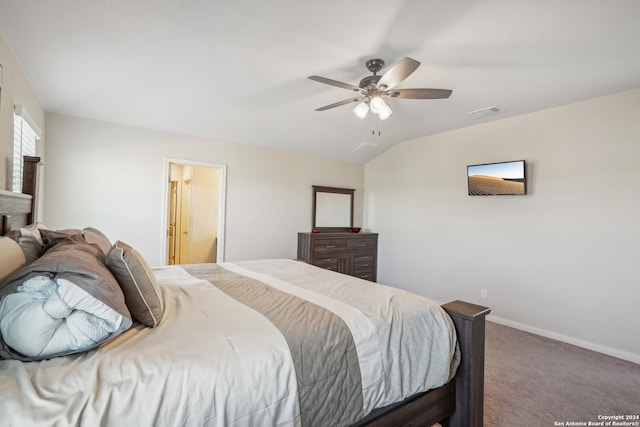 carpeted bedroom featuring ensuite bath, vaulted ceiling, and ceiling fan