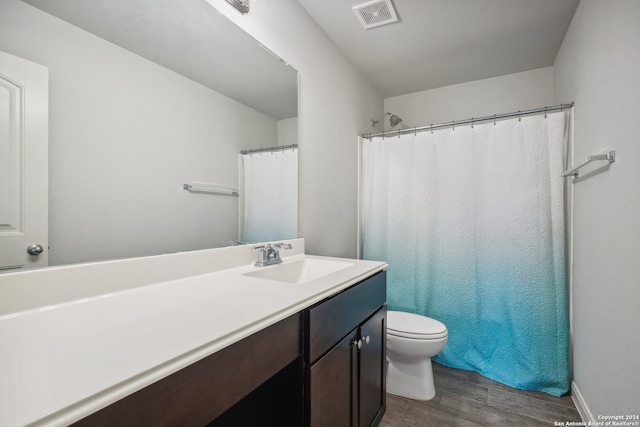 bathroom with toilet, vanity, wood-type flooring, and a shower with shower curtain