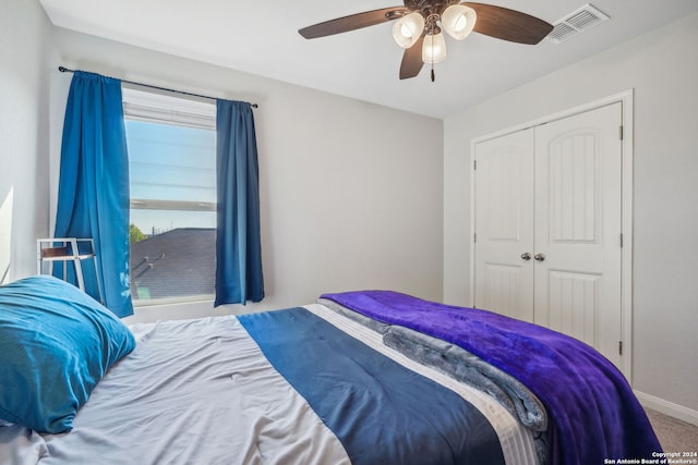 bedroom with a closet, carpet, and ceiling fan