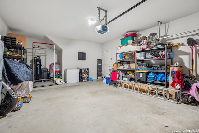 garage with a garage door opener and refrigerator