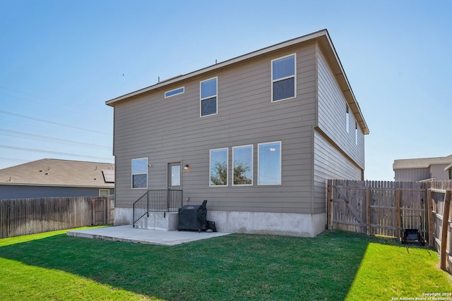 rear view of house with a patio area and a yard