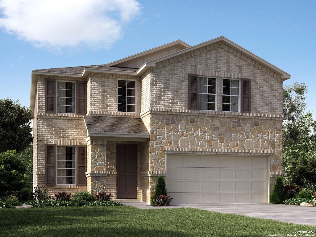 view of property with a front yard and a garage