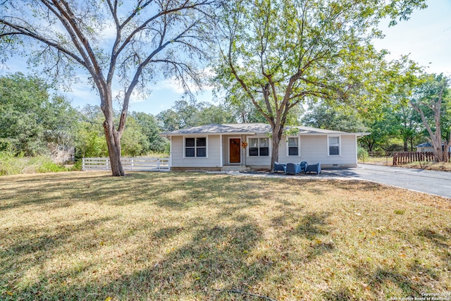 ranch-style home with a front lawn