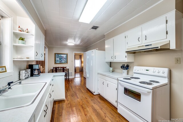 kitchen with ornamental molding, sink, light wood-type flooring, white cabinets, and white appliances