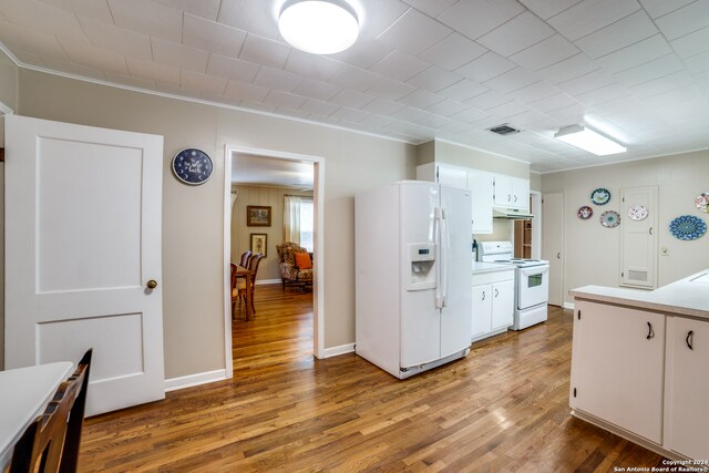 kitchen featuring ornamental molding, white cabinets, light hardwood / wood-style flooring, and white appliances