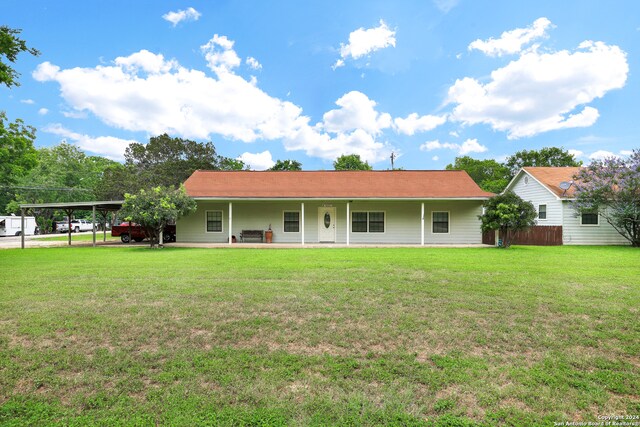 view of front of house featuring a carport, a front yard, and a porch