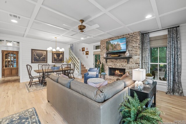 living room featuring coffered ceiling and light wood-type flooring