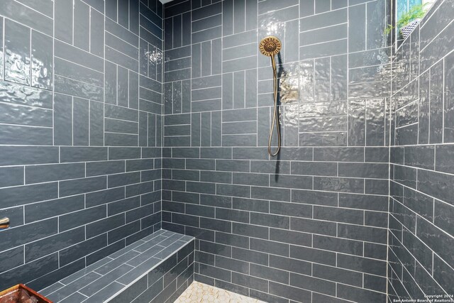 bathroom with tiled shower