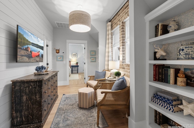 living area featuring light hardwood / wood-style floors and built in features