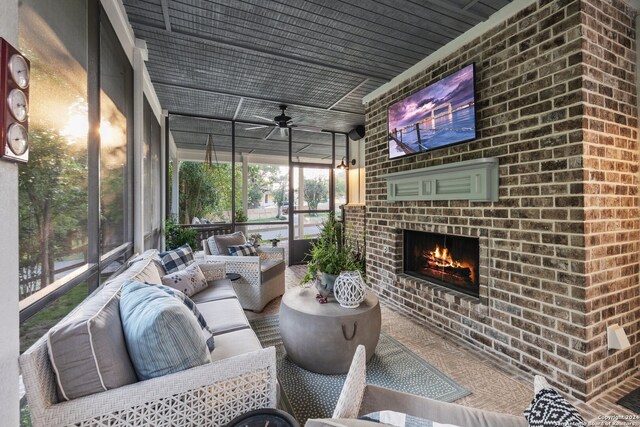 sunroom / solarium featuring an outdoor brick fireplace and ceiling fan