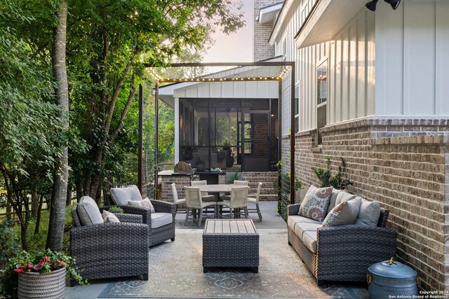 patio terrace at dusk featuring a sunroom and outdoor lounge area