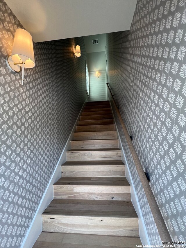 staircase featuring hardwood / wood-style floors