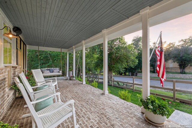 patio terrace at dusk featuring an outdoor hangout area