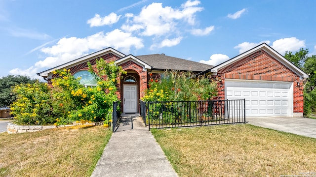 view of front of home with a front yard and a garage