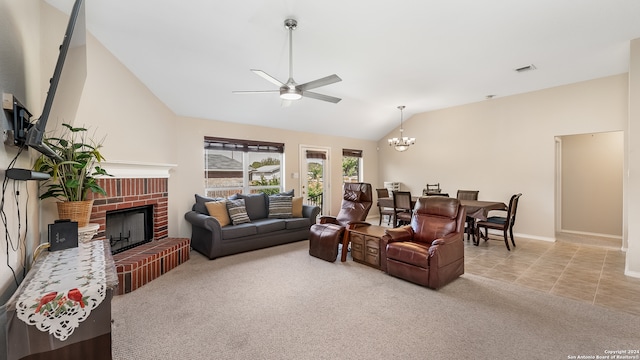 living room with vaulted ceiling, a brick fireplace, ceiling fan with notable chandelier, and light tile patterned flooring