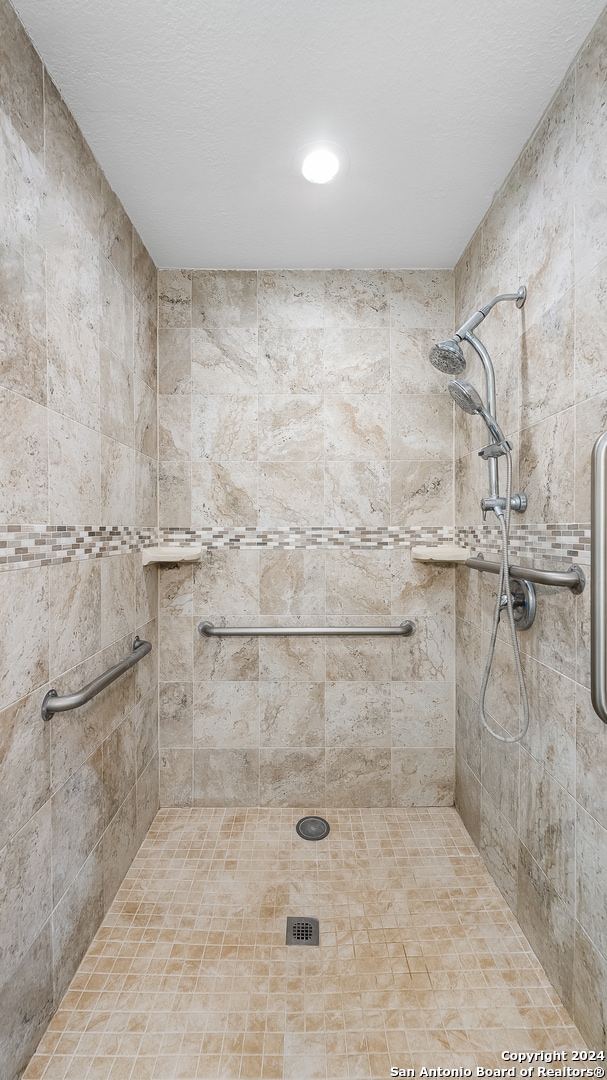 bathroom with tiled shower