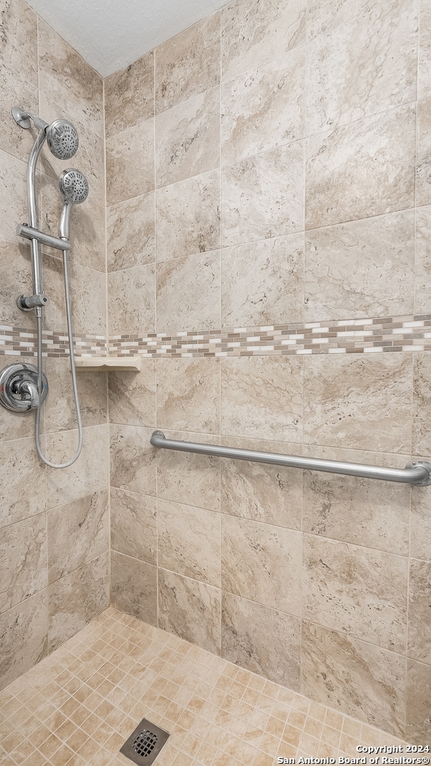 bathroom with a tile shower