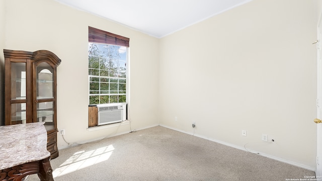 empty room featuring cooling unit and carpet floors