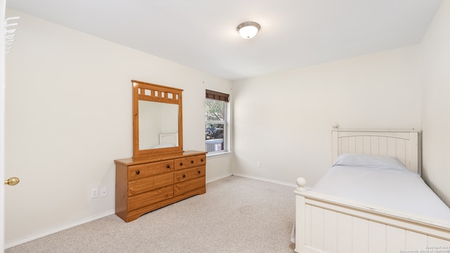 bedroom with light colored carpet