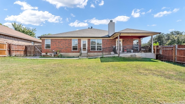 1042 Segovia, New Braunfels, TX 78130 - rear view of house featuring a lawn, a chimney, and brick siding