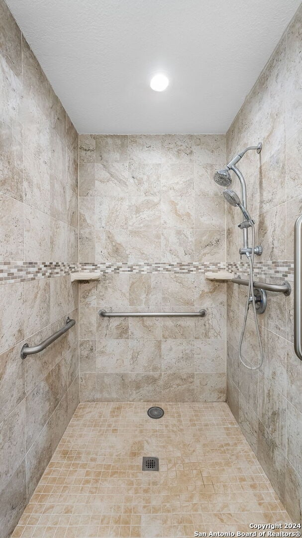 bathroom with a tile shower