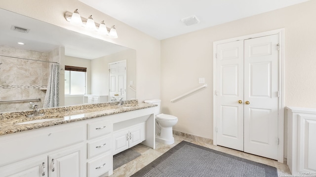 bathroom with vanity, toilet, and walk in shower