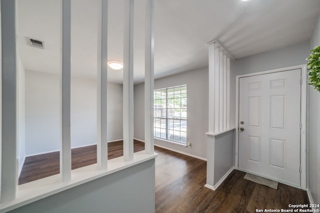 entryway featuring dark wood-type flooring, visible vents, and baseboards