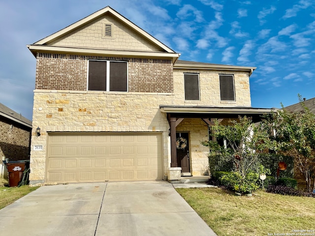 view of front facade with a front yard and a garage