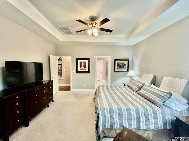 carpeted bedroom with ornamental molding, a raised ceiling, and ceiling fan