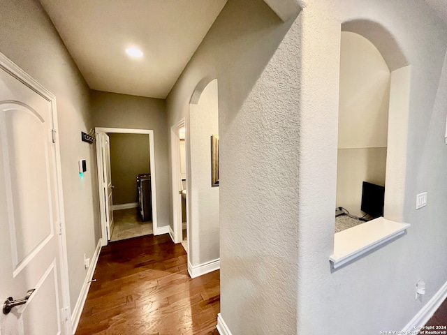 corridor featuring dark hardwood / wood-style flooring