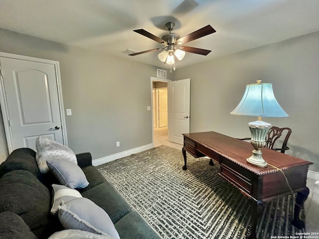 carpeted home office with ceiling fan