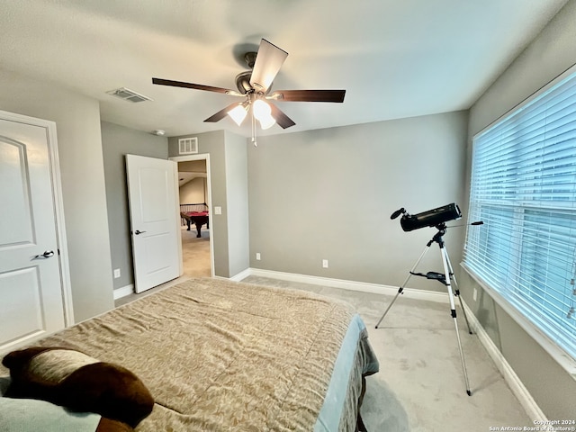 bedroom with ceiling fan and light colored carpet